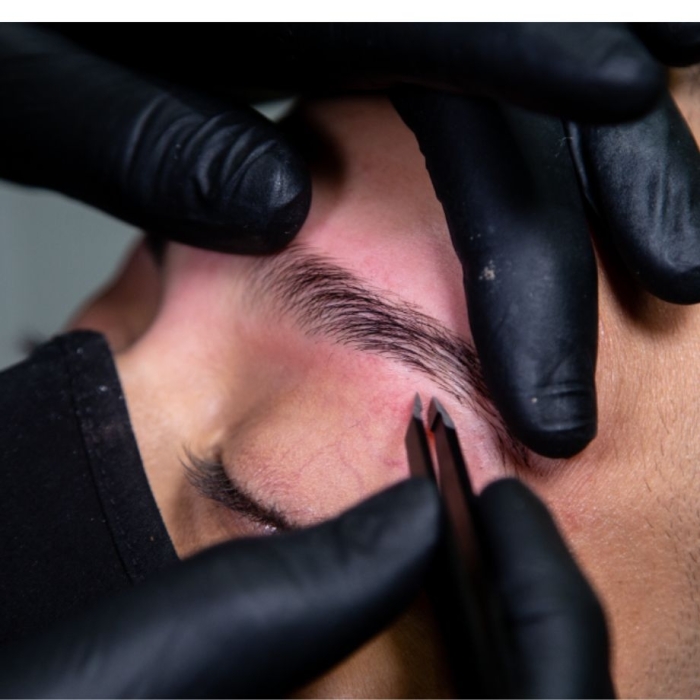 Eyebrow tweezing close up