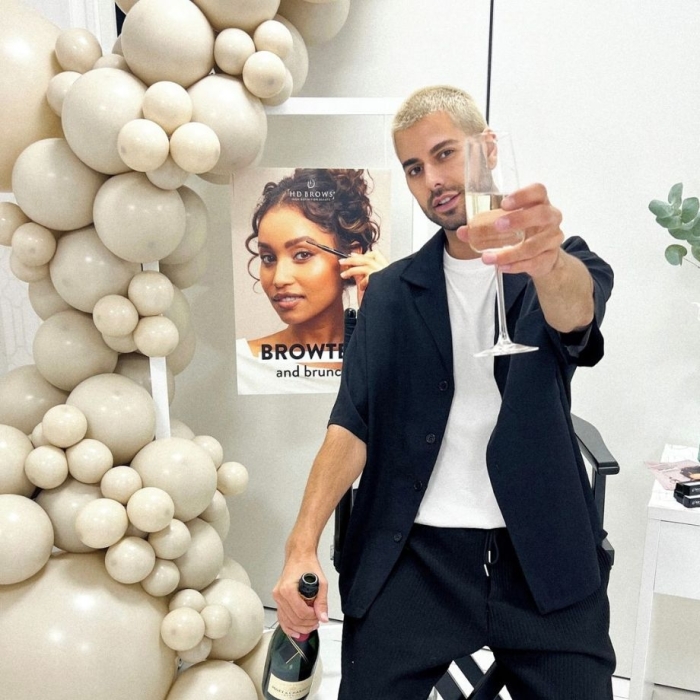 Jamie holding glass of champagne