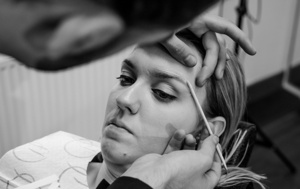 Stylist applying wax to client during HD Brows treatment